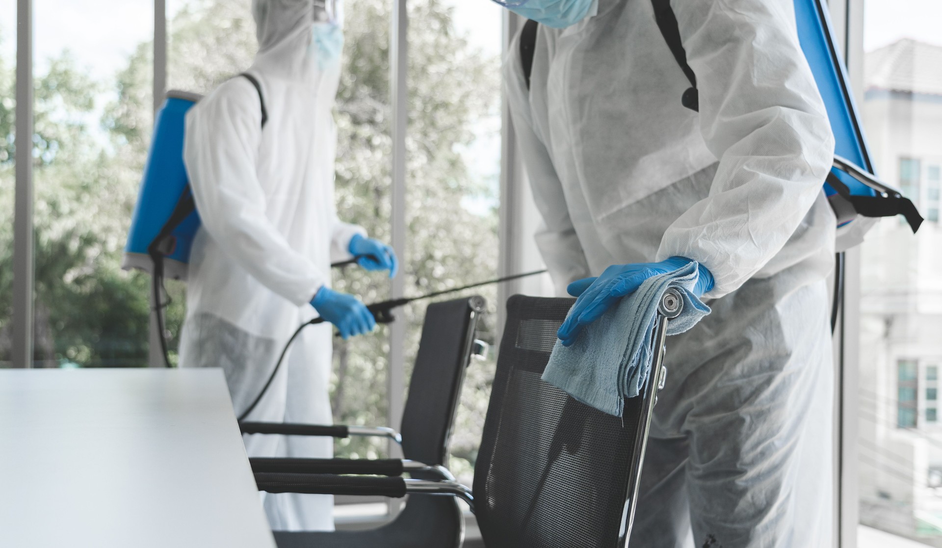 Man in virus protective suit and mask spraying alcohol cleaning covid19 infected area, Virus disinfection concept